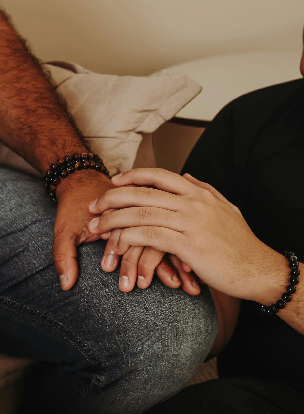 One person's hand gently holding another's in support.