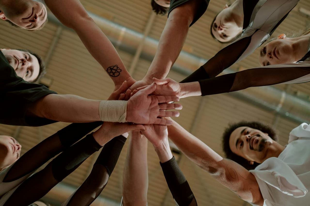 Hands joining together in support.